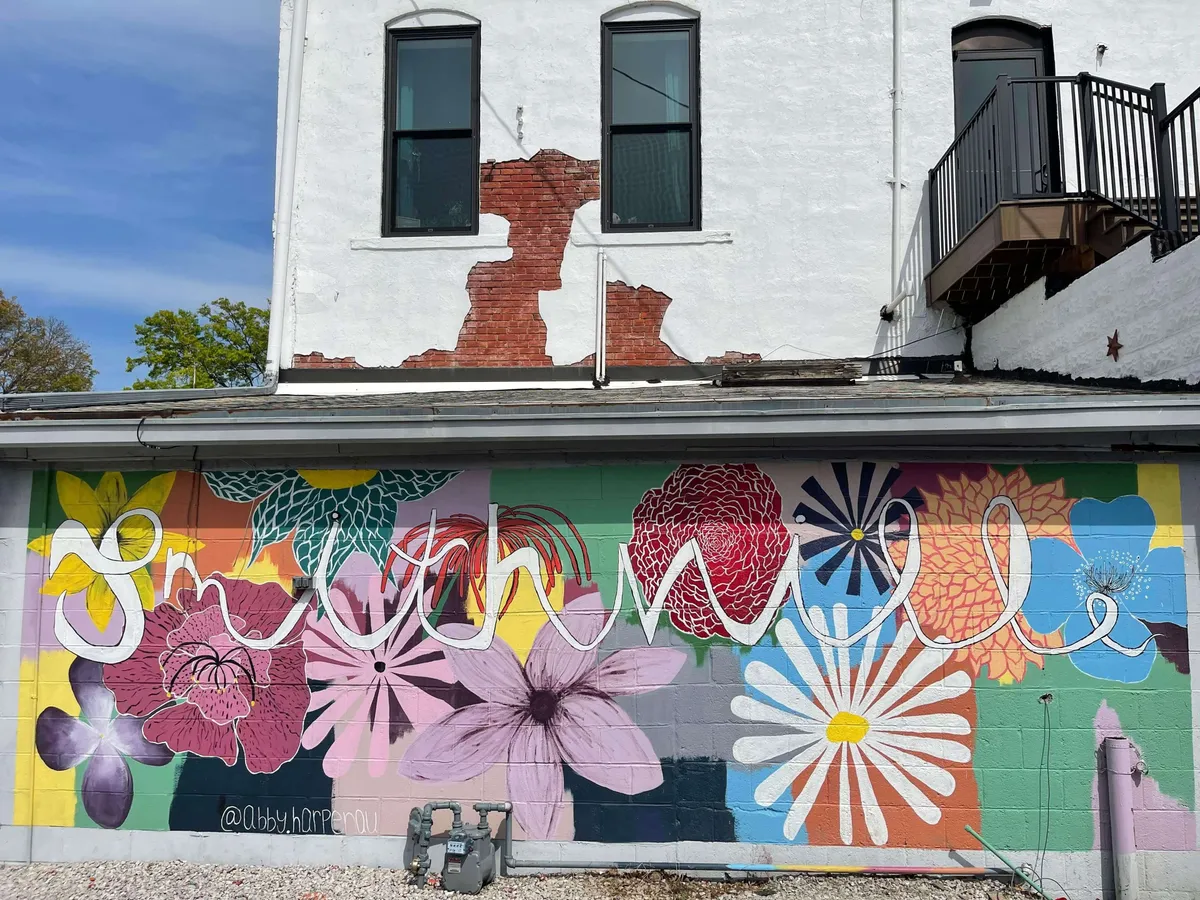 A colorful exterior mural painted on a brick wall, featuring bold graphics and text. This mural highlights Smithville’s appreciation for local art and provides a playful, contemporary contrast to the town’s historic elements.